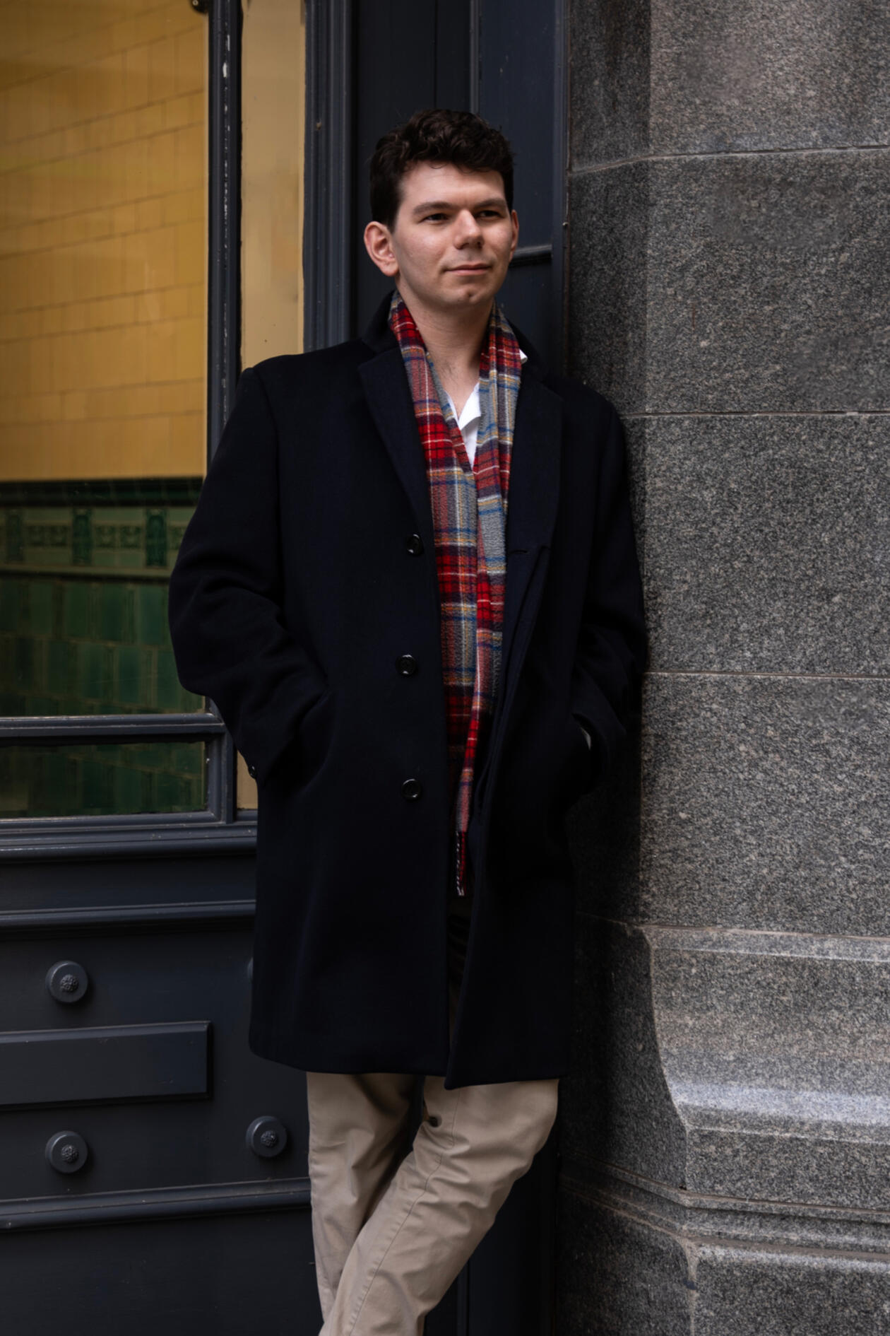 James sat on park bench leaning forwards