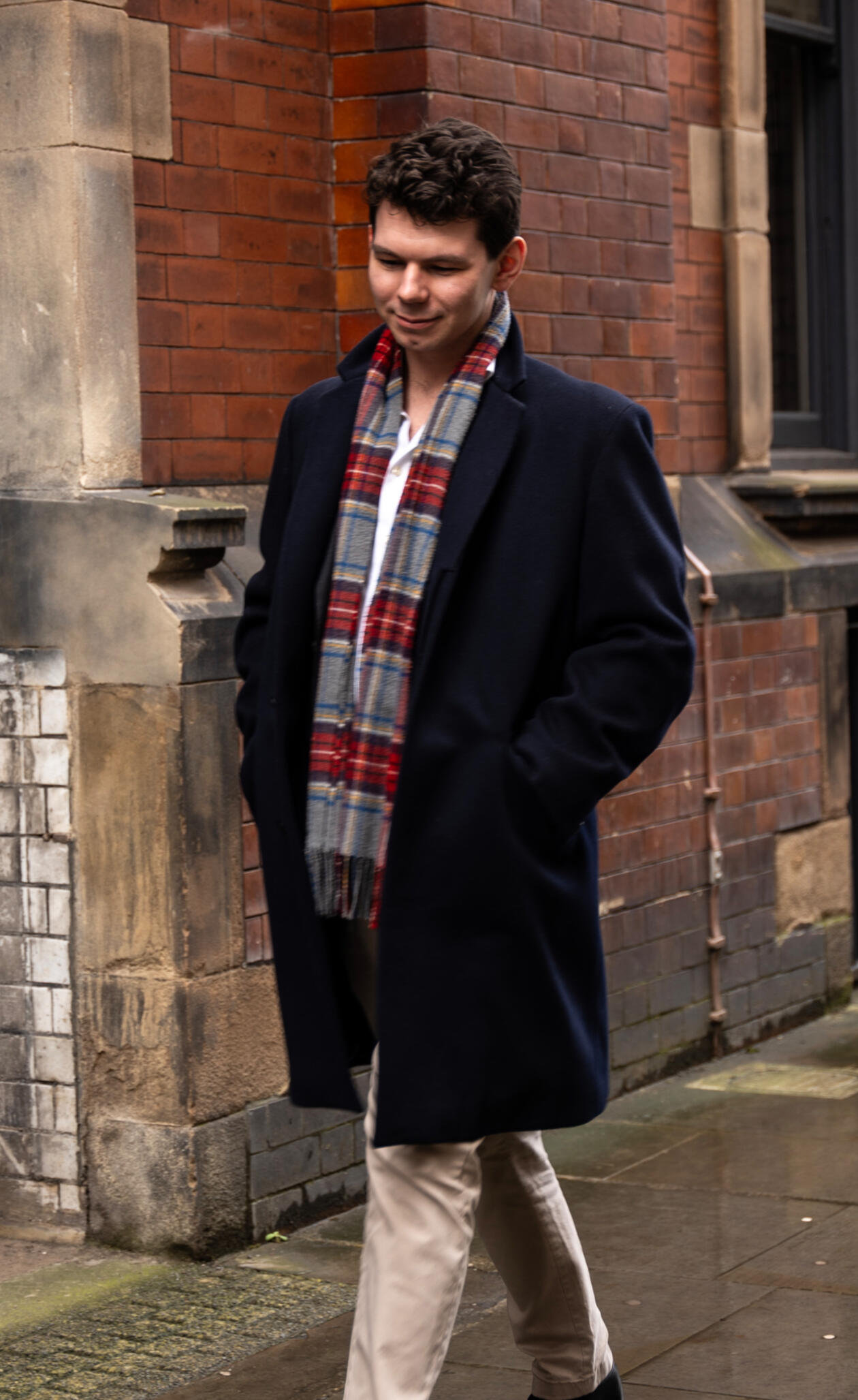 James sat on park bench leaning backwards